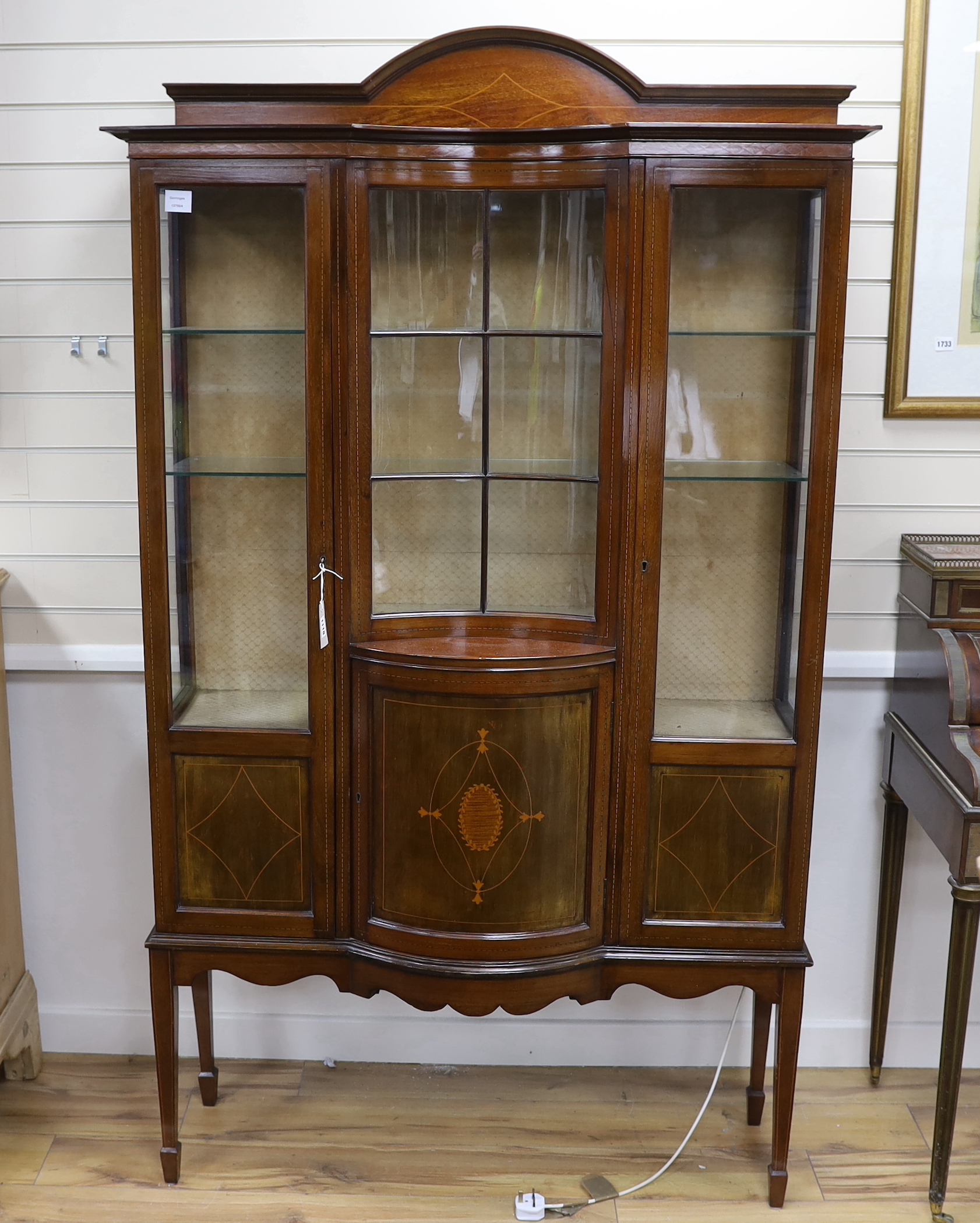 An Edwardian inlaid mahogany concave and bow front display cabinet, width 115cm, depth 36cm, height 197cm